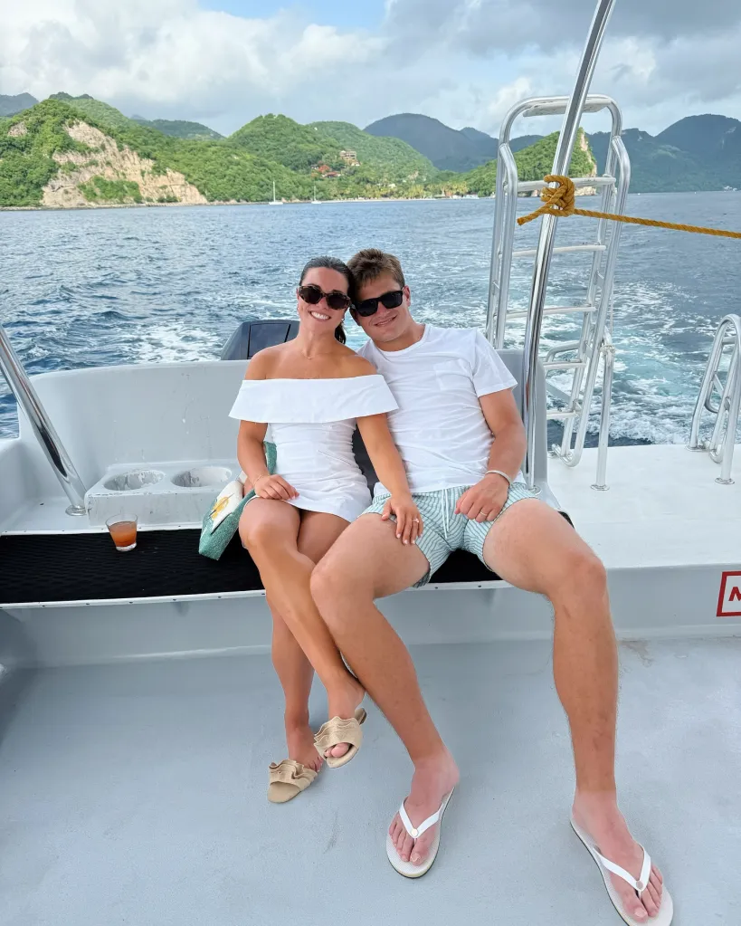 Drake Maye and Ann Michael Maye smiling on a boat with mountains in the background.