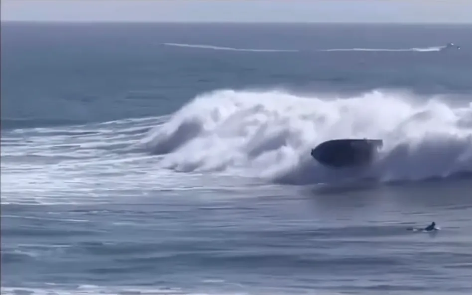 Boat being thrown out of a wave.