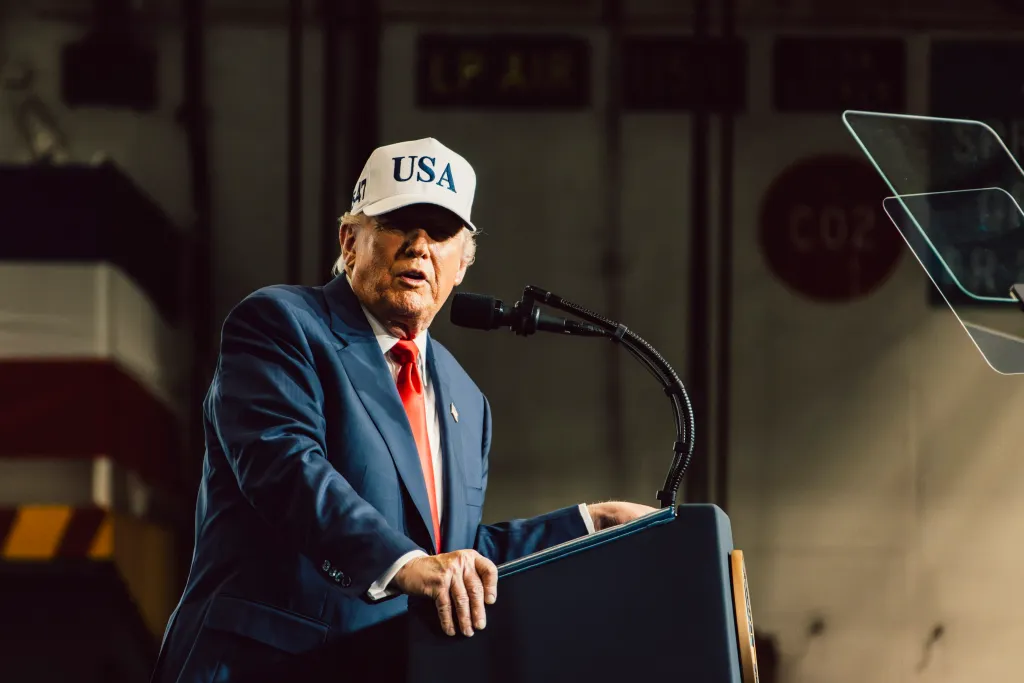 President Donald Trump addressing sailors on the USS George Washington (CVN 73) while wearing a white 