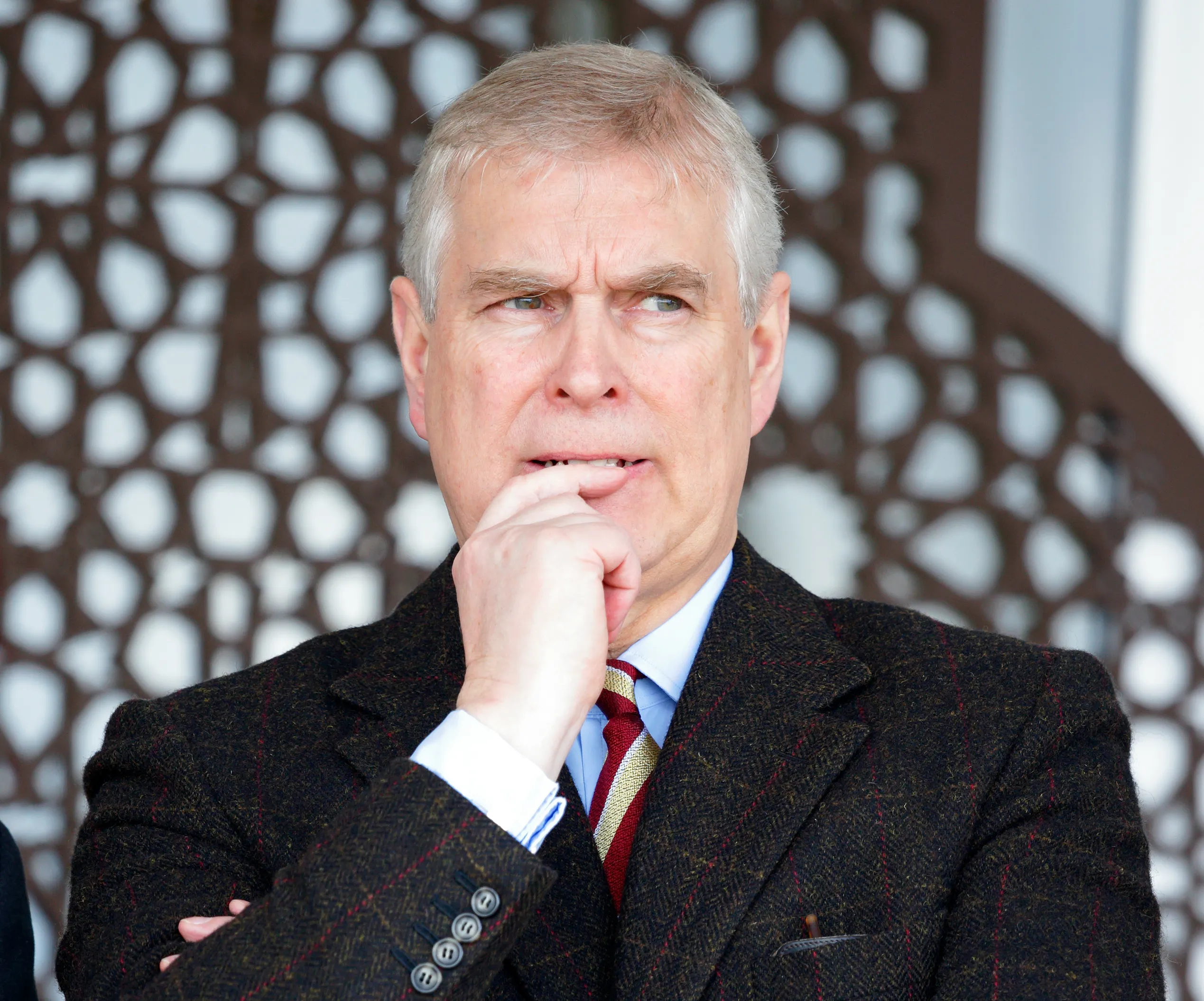 Prince Andrew, Duke of York, bites his fingernail while attending the Royal Windsor Horse Show.