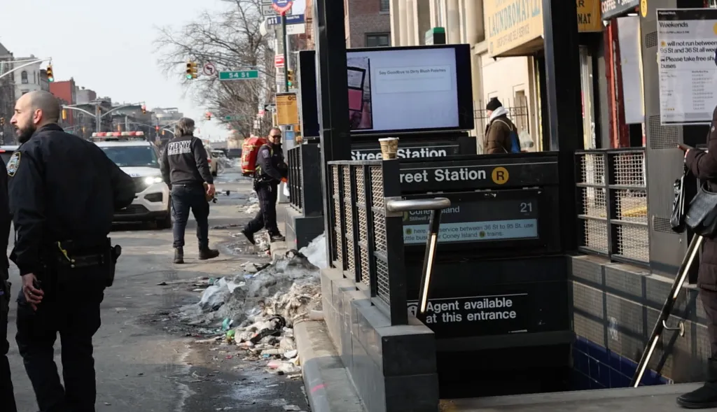 Police officers and EMTs respond to an incident at the 53rd Street subway station in Brooklyn.