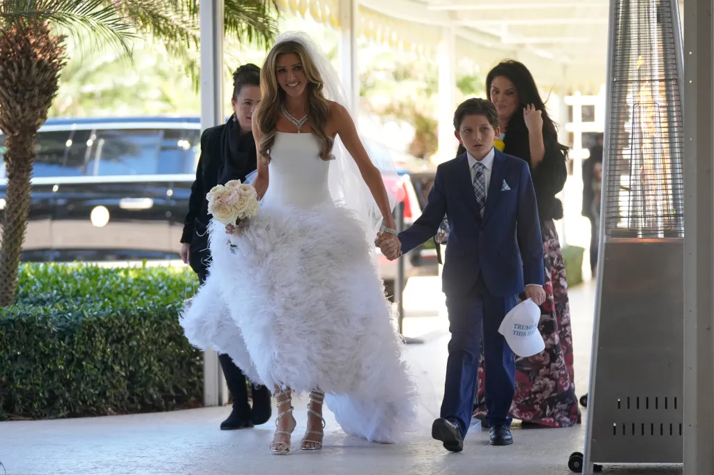 Erin Elmore, director of Art in Embassies, arrives for her wedding with a young boy holding a