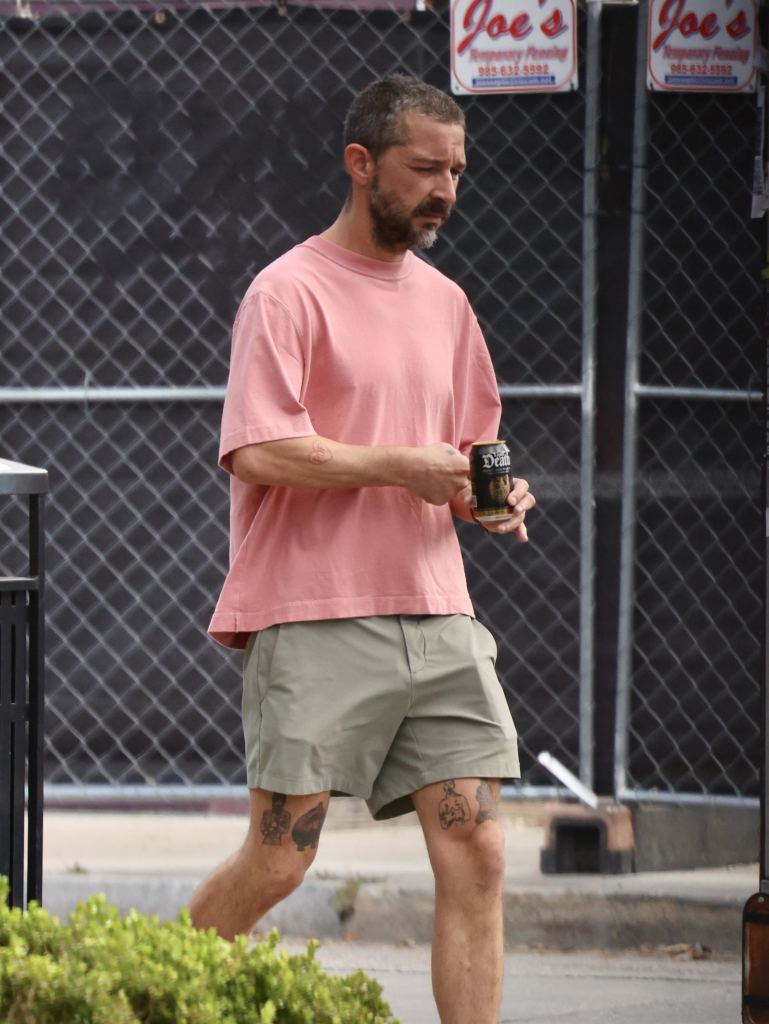 Shia LaBeouf walking in New Orleans, holding a 