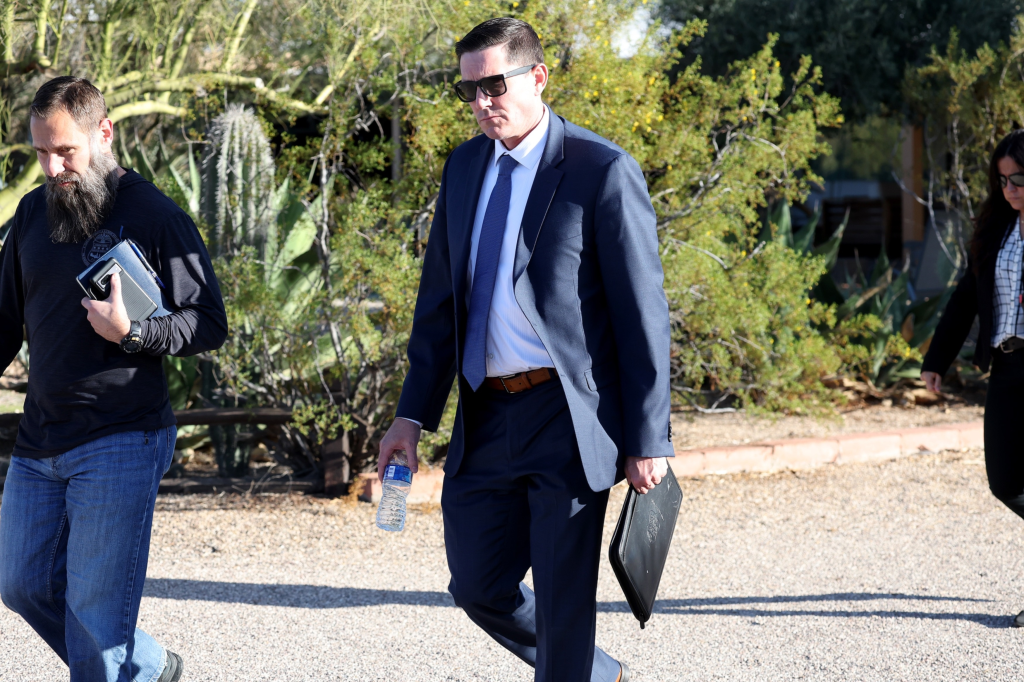 Law enforcement, including FBI and sheriffs, leaving Annie Guthrie's Tucson home.