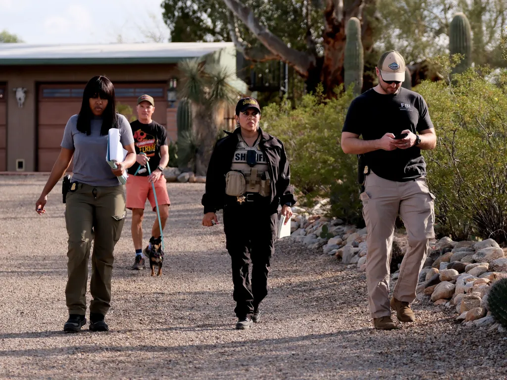 FBI agents and local authorities conducting a door-to-door search for a missing person.