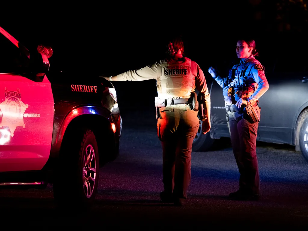 Law enforcement officials outside a home in Rio Rico, Arizona, on Feb. 10, 2026.