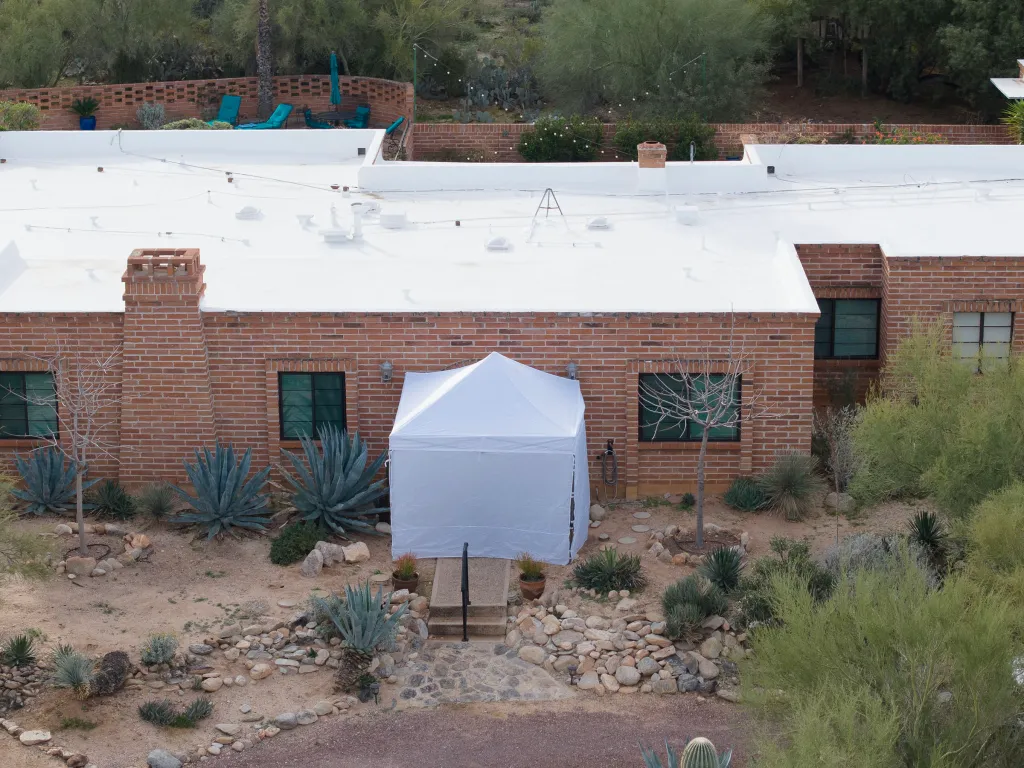 A white tent is erected outside Nancy Guthrie's home in Tucson, Arizona on Feb. 12, 2026.