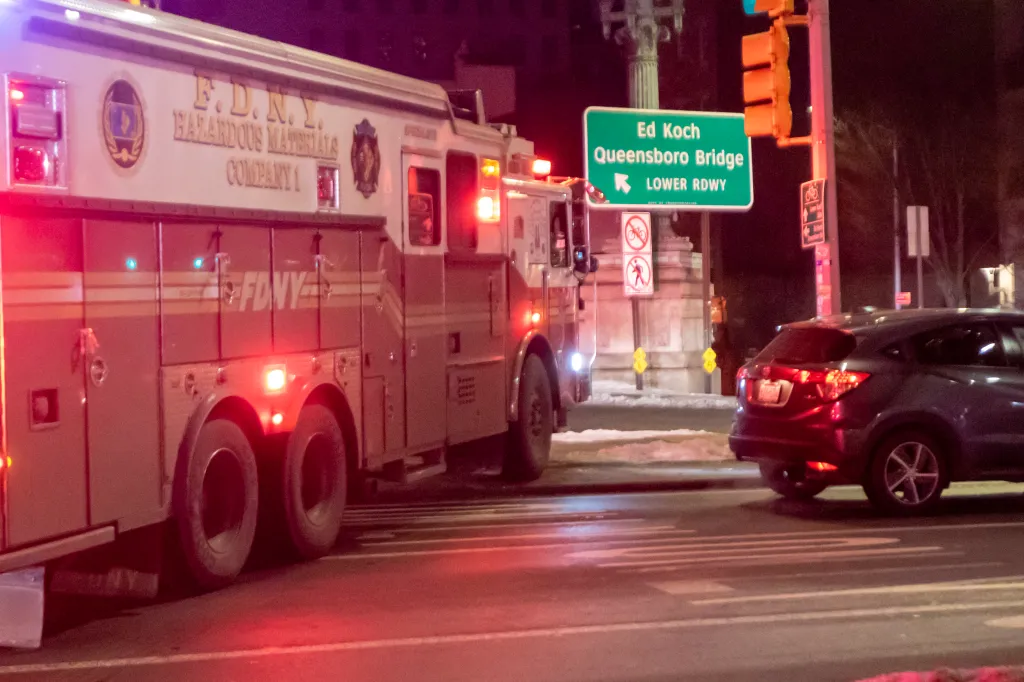 FDNY Hazardous Materials Company 1 truck with flashing lights at the Ed Koch Queensboro Bridge.
