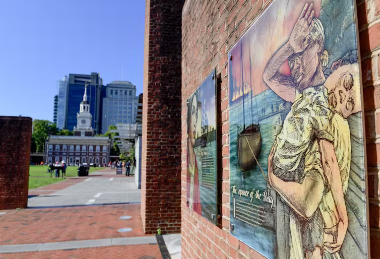 Colorful illustration on a panel on wall of brick building