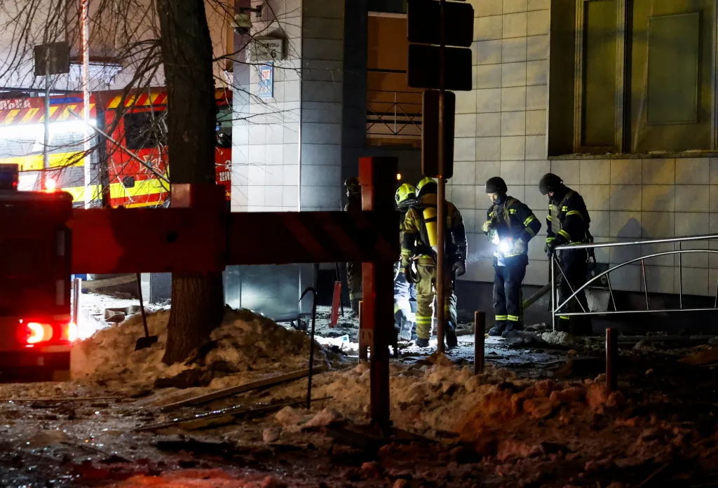 Firefighters work outside an apartment building after it was struck by a drone during Russian missile and drone attacks