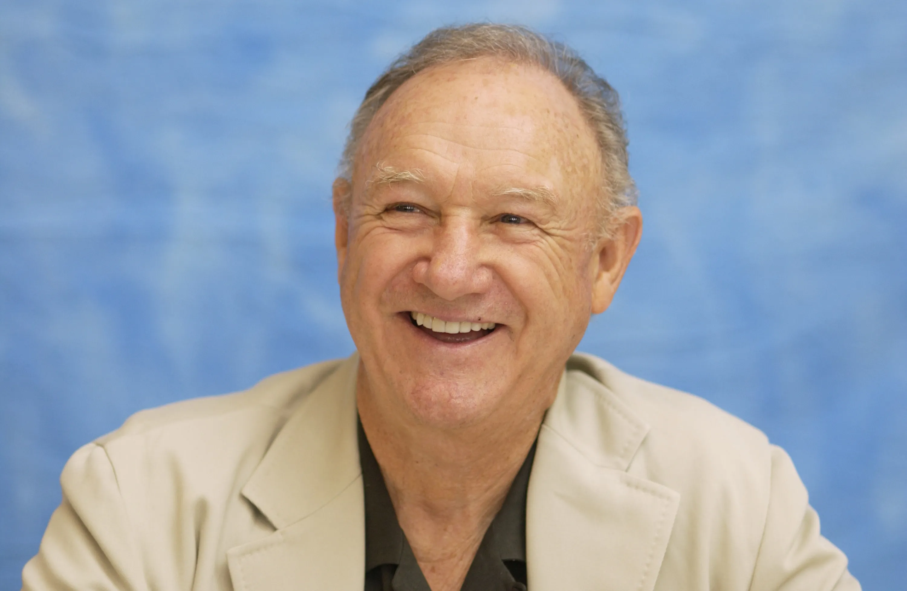Gene Hackman smiling during a 