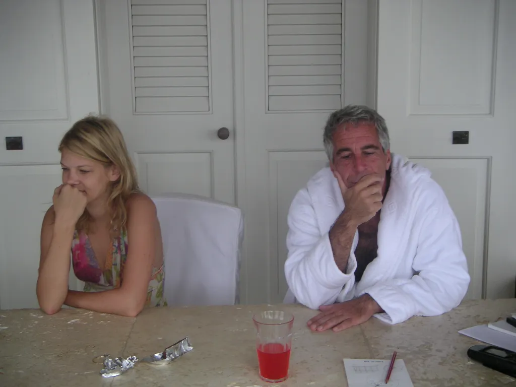 Nadia Marcinkova and Jeffrey Epstein sit at a table.