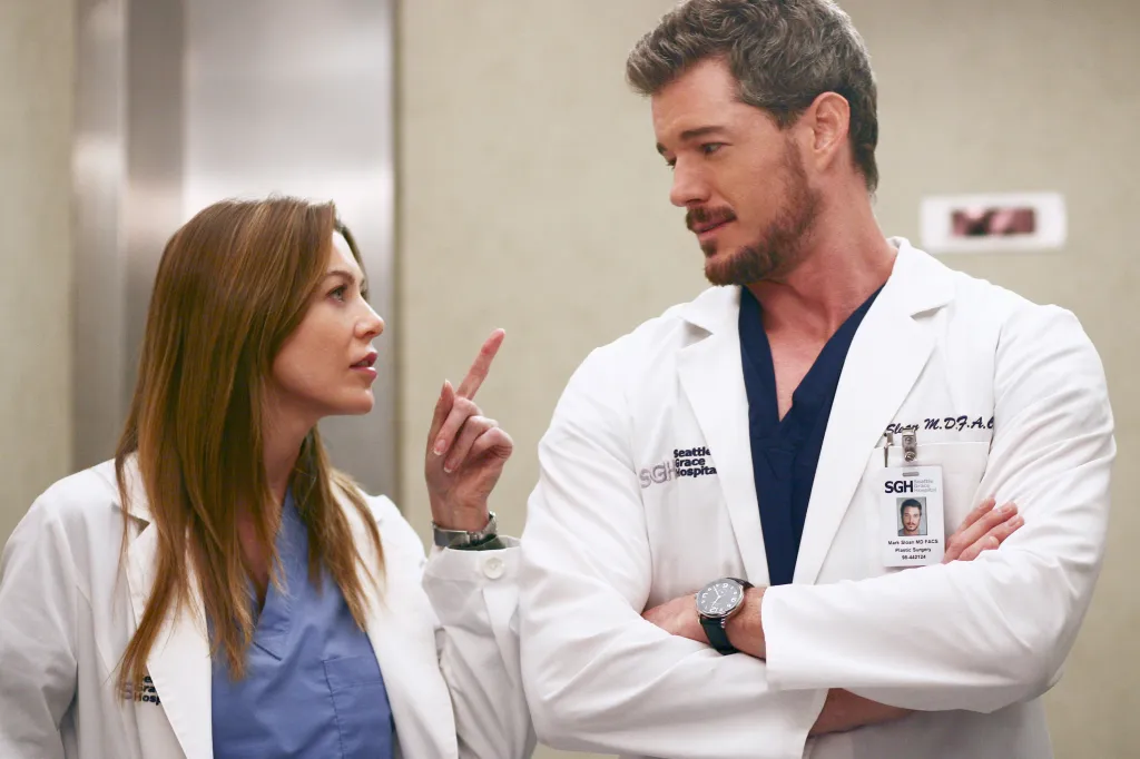 Ellen Pompeo and Eric Dane as doctors in lab coats, talking in a hospital.