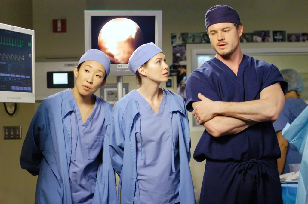 Sandra Oh, Ellen Pompeo, and Eric Dane as doctors in hospital scrubs.