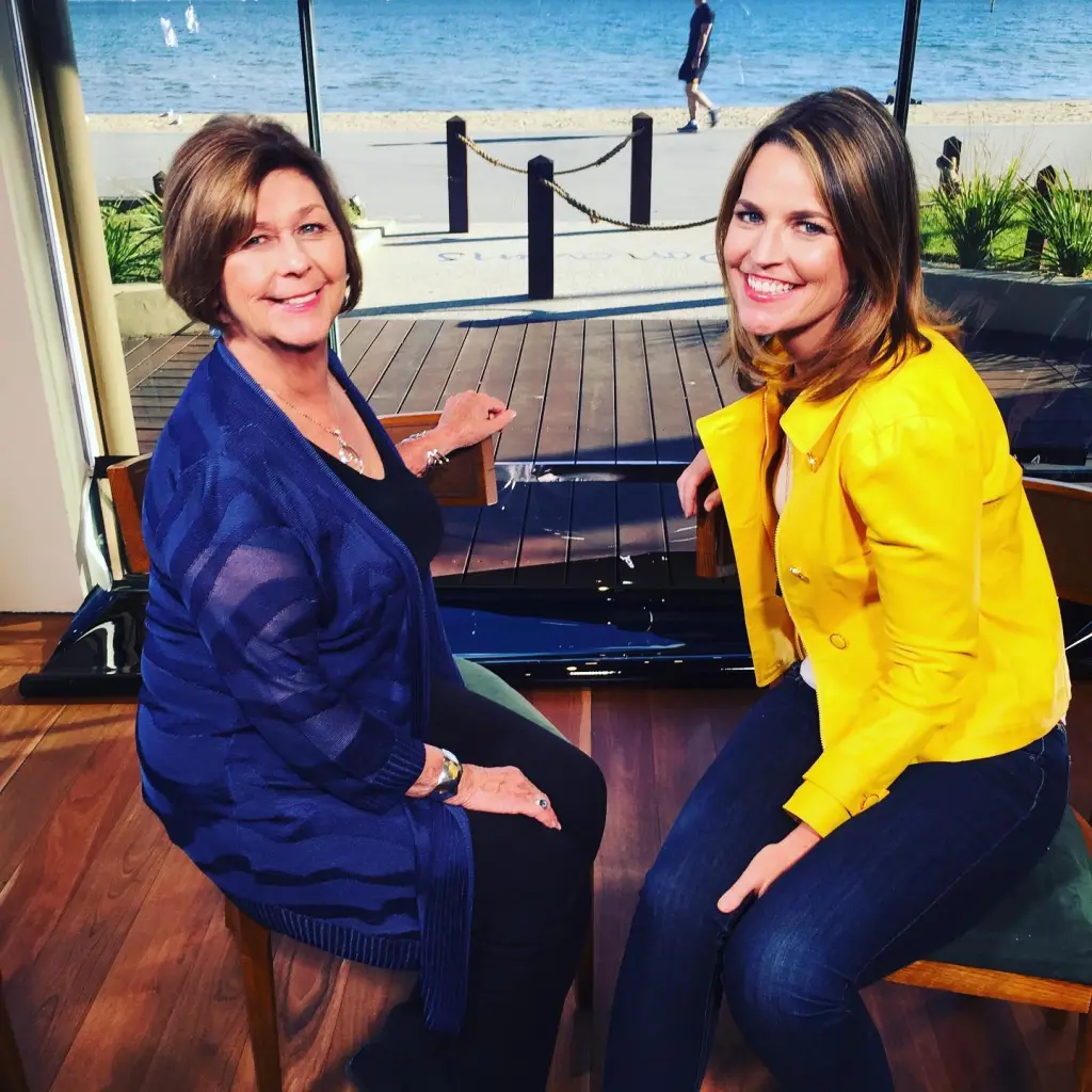 Savannah Guthrie and her mother Nancy Guthrie smiling at the camera with a beach in the background.