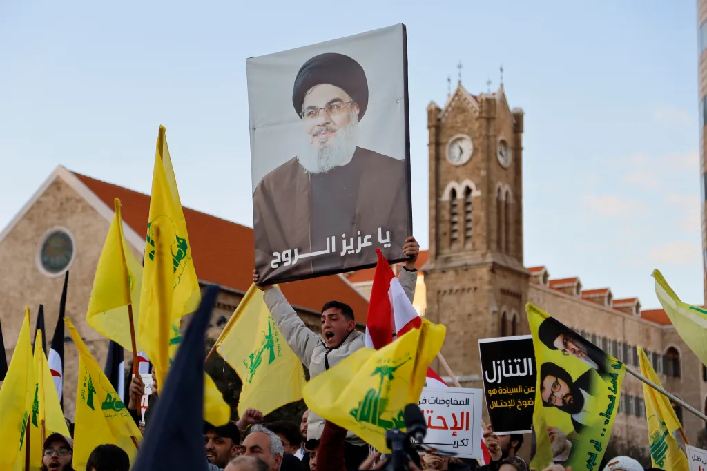 Hezbollah supporters carry a large portrait of former Secretary-General Hassan Nasrallah during the mass rally.