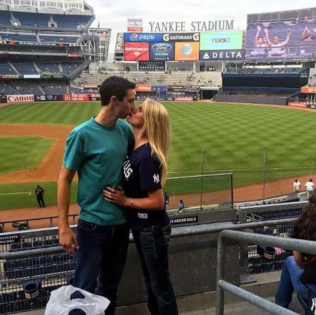 A couple kisses in the stands at Yankee Stadium.