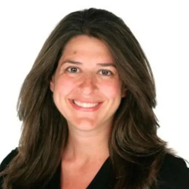 Hunter College Professor Alysson Friedman smiling at the camera.