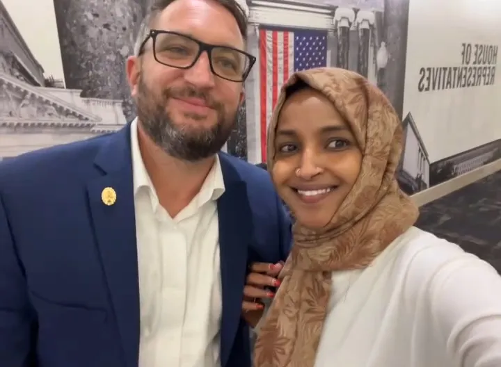 Ilhan Omar and Tim Mynett smiling together.