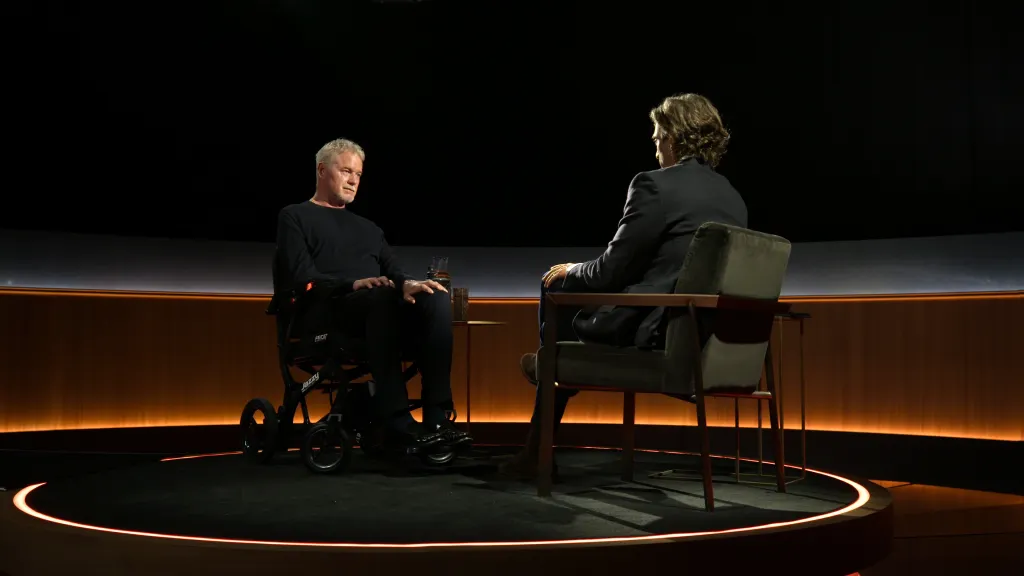 Eric Dane in a wheelchair and Brad Falchuk talking in an interview for 