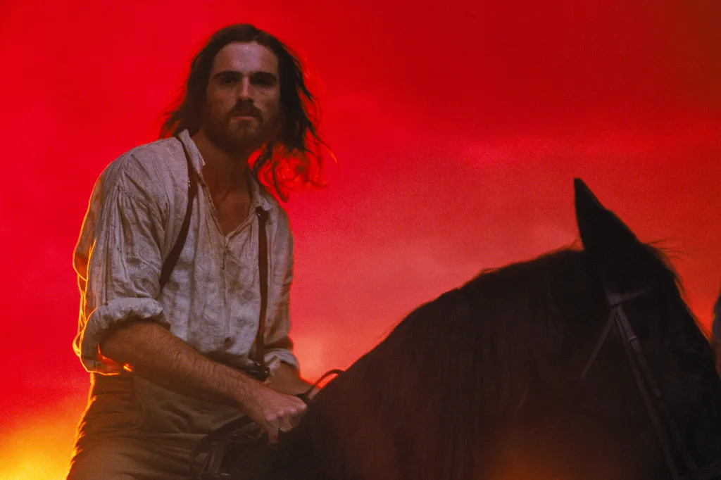 Jacob Elordi as Heathcliff on horseback in a scene from