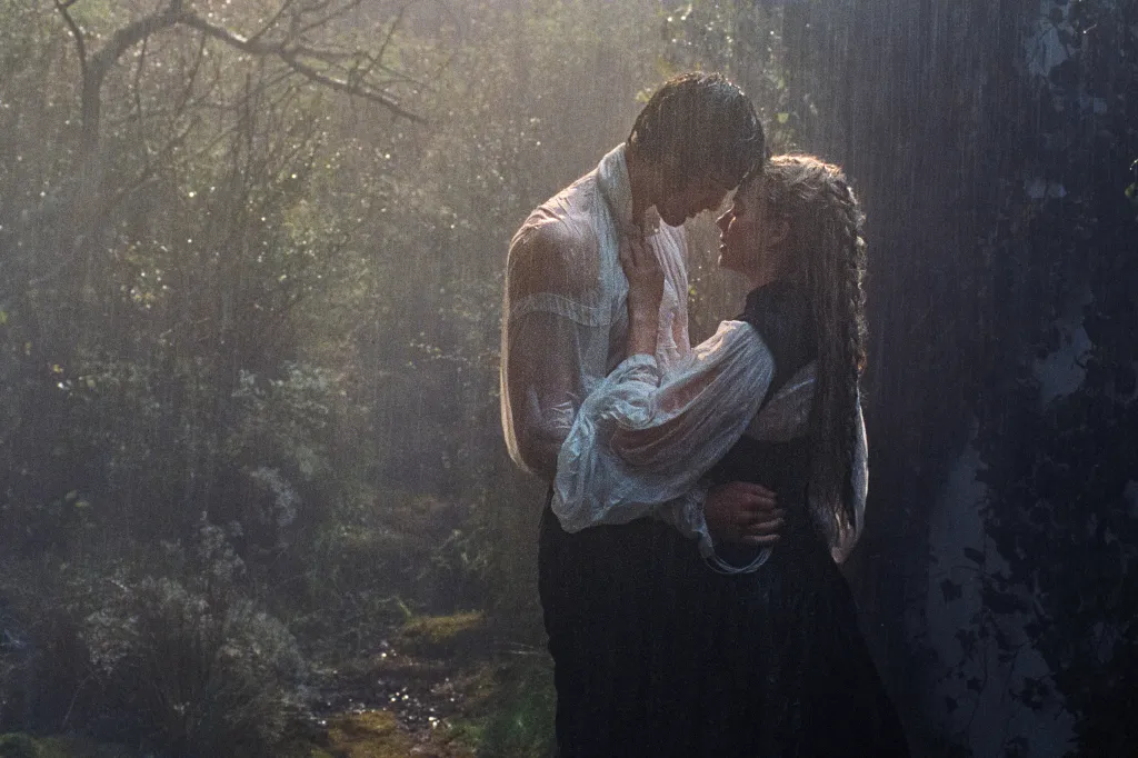Margot Robbie and Jacob Elordi embrace in the rain in a scene from