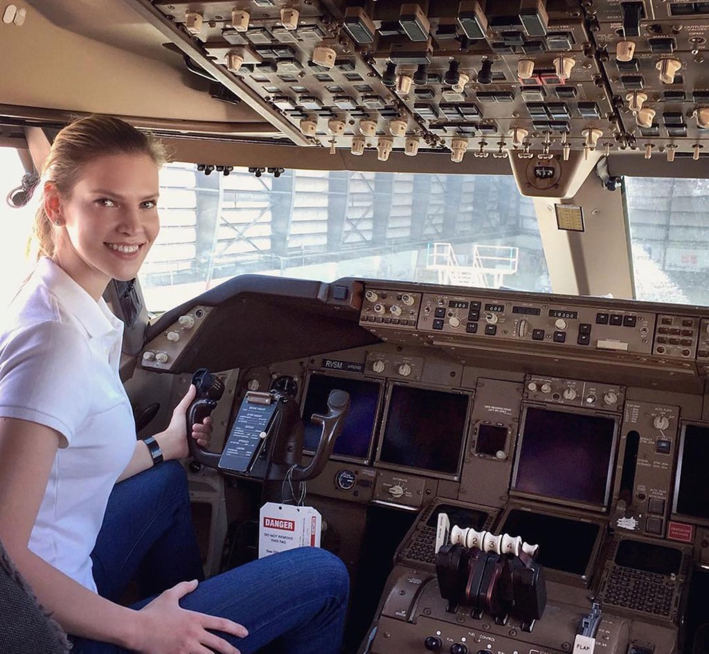 Nadia Marcinko, known for her involvement in Jeffrey Epstein's sex trafficking, sits in the cockpit of a plane.