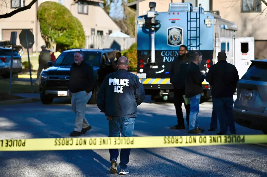 Immigration and Customs Enforcement agents and other law enforcement officials investigate a shooting in Glen Burnie, Maryland. 