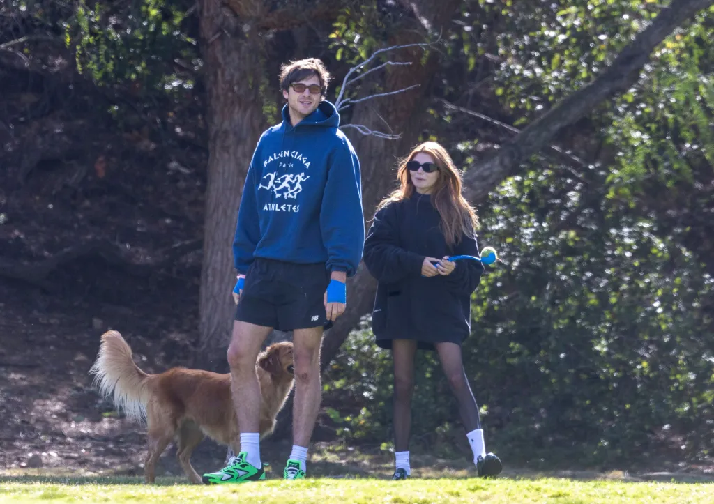 Jacob Elordi and Olivia Jade at a dog park with a golden retriever.