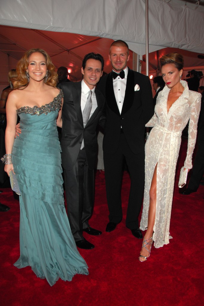 Jennifer Lopez, Marc Anthony, David Beckham, and Victoria Beckham pose on a red carpet.