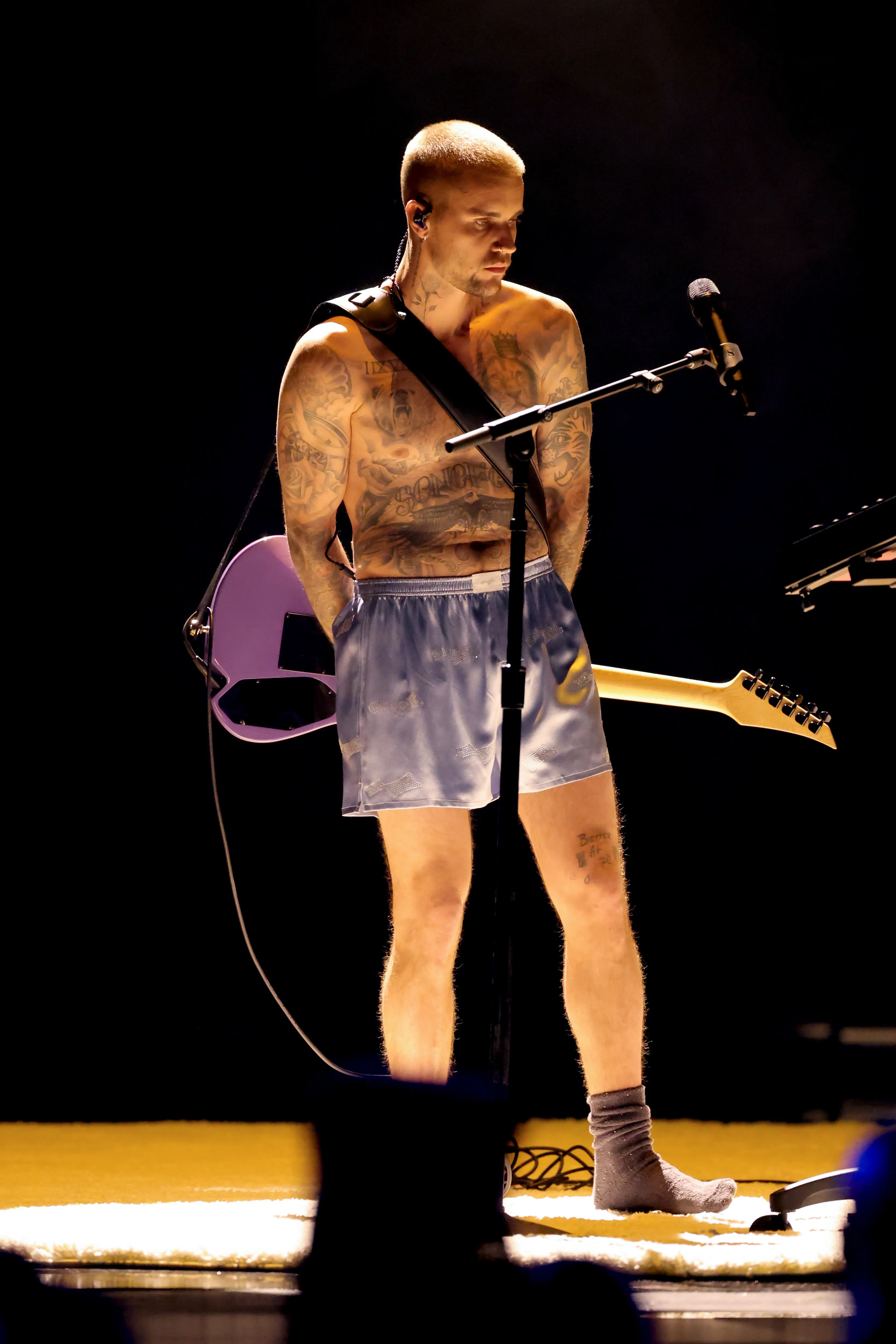 Justin Bieber performing at the Grammys onstage covered in tattoos