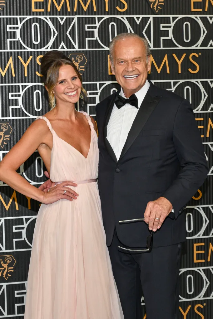 Kayte Walsh and Kelsey Grammer smiling on the red carpet at the 75th Primetime Emmy Awards.
