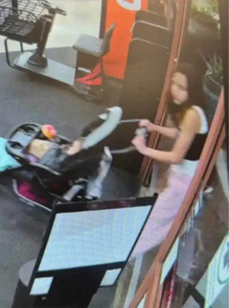 Kehlani Rogers in a car seat inside a stroller being pushed by a woman.