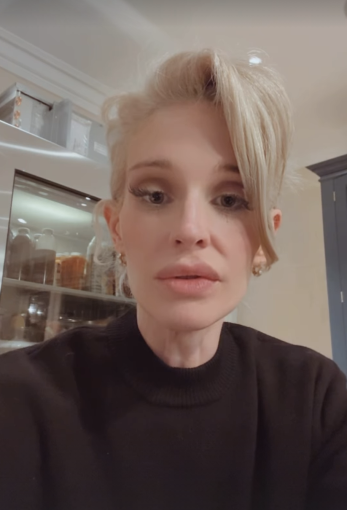 Kelly Osbourne with blonde hair and a black top.