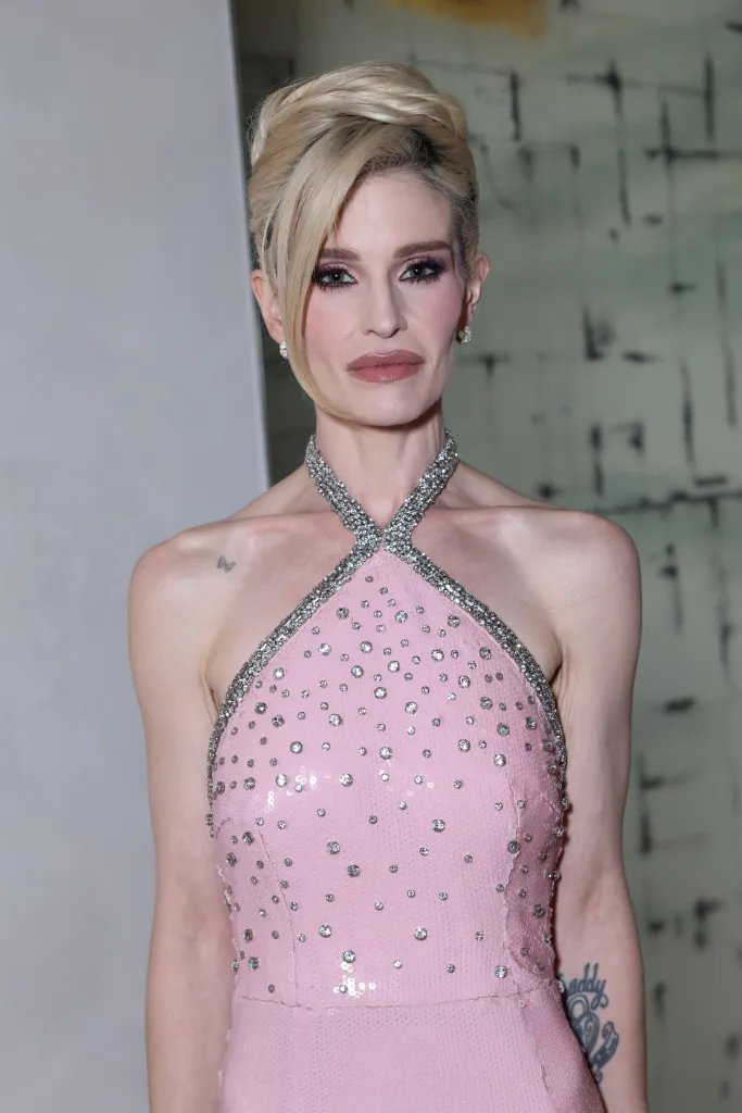 Kelly Osbourne in a pink sequined and embellished halter neck dress.