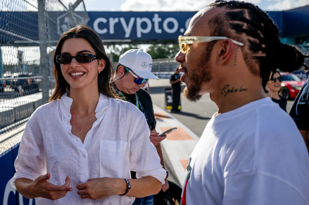 Kendall Jenner and Lewis Hamilton talking at the Miami Grand Prix.
