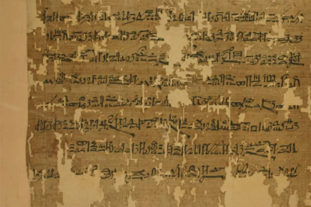 Close-up of the ancient Egyptian Papyrus Anastasi I, with hieratic script written in black ink on a weathered, light brown background.