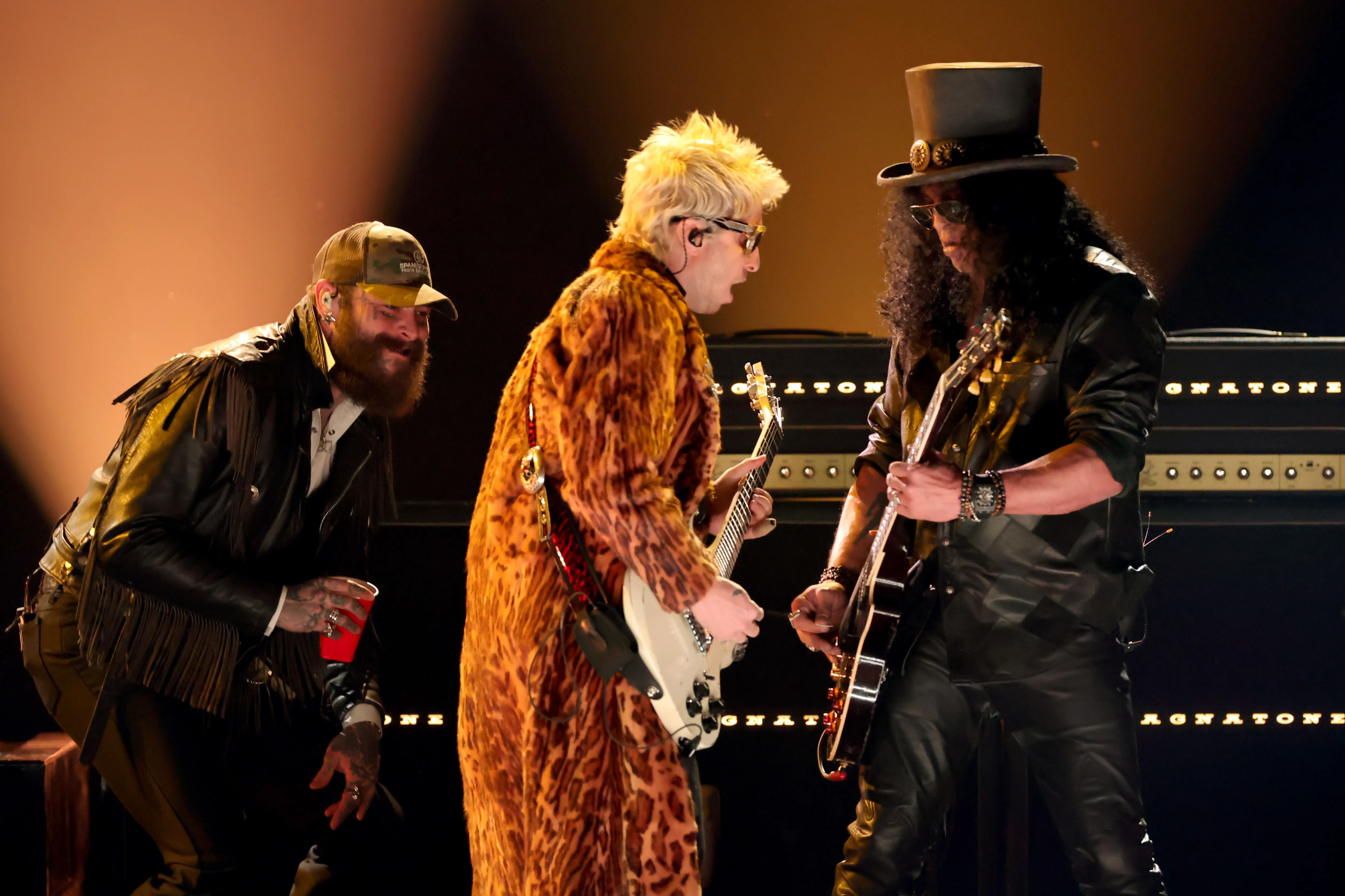 Post Malone (from left), Guns N' Roses' Slash and producer Andrew Watt onstage performing the Ozzy Osbourne tribute.
