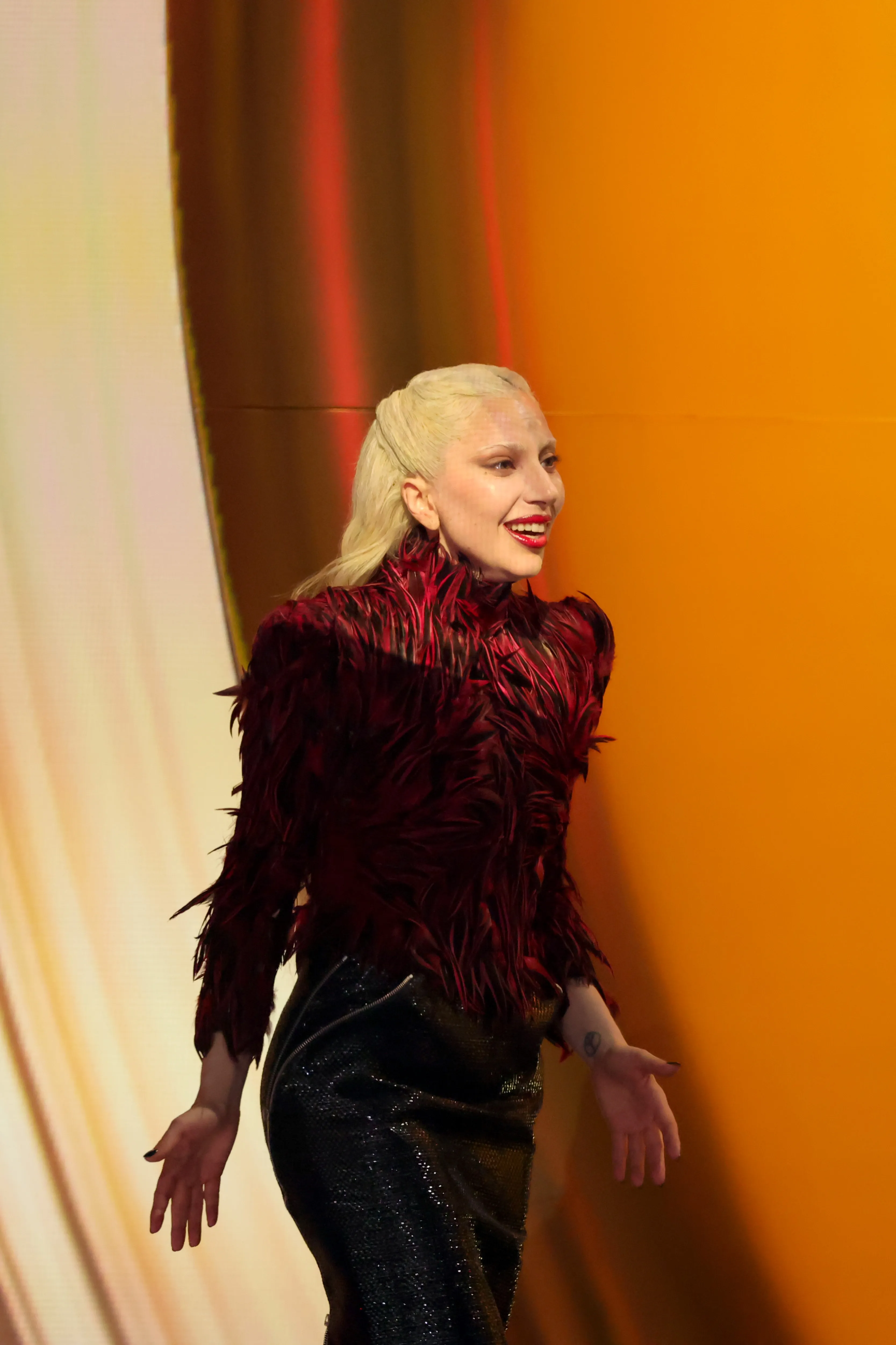 Lady Gaga smiling while accepting an award at the 68th GRAMMY Awards.