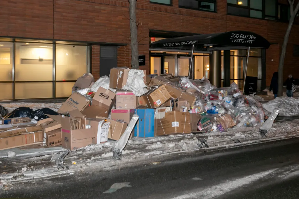 Large piles of trash and recycling in front of 300 East 39th Street Apartments in Midtown, Manhattan.