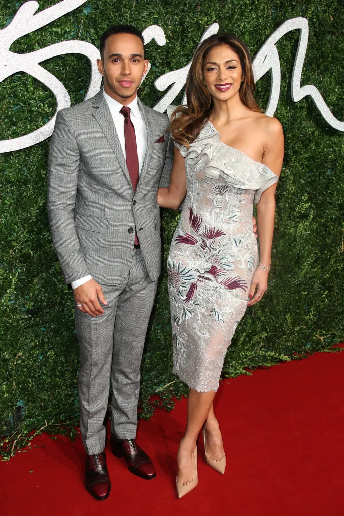 Lewis Hamilton and Nicole Scherzinger on a red carpet.