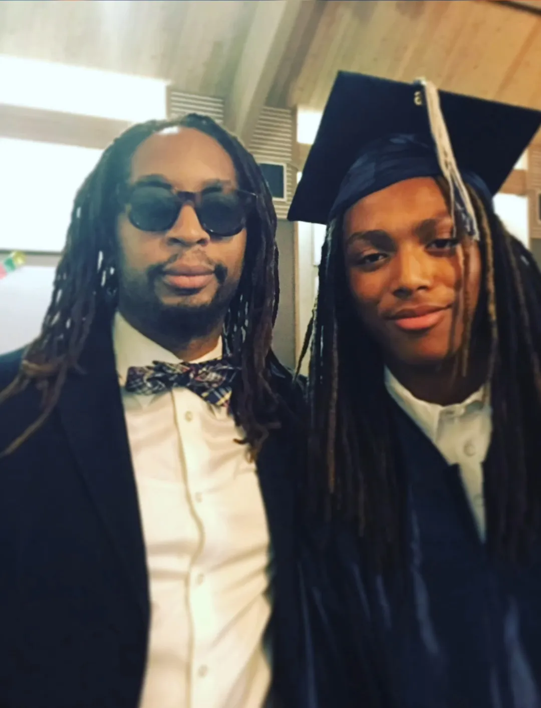 Lil Jon with his son Nathan, wearing a graduation cap and gown.