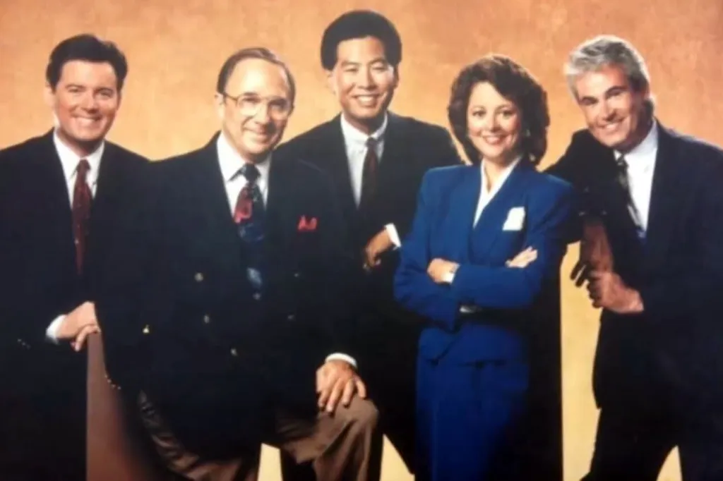 Five news anchors, including Dick Cable, posing for a group photo.