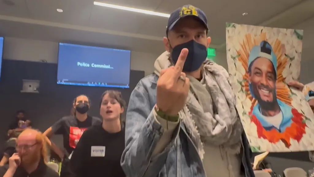 A man wearing a face mask and a hat that says 