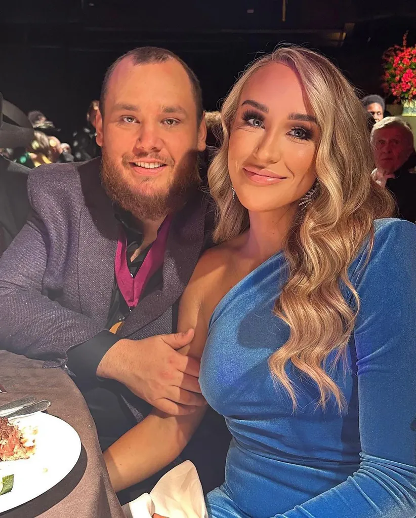 Luke Combs and Nicole Hocking smiling at an event.