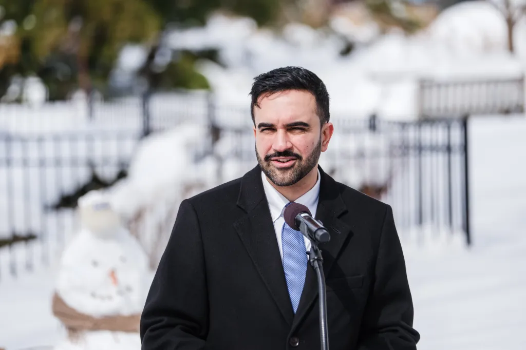 Zohran Mamdani speaking at a press conference.