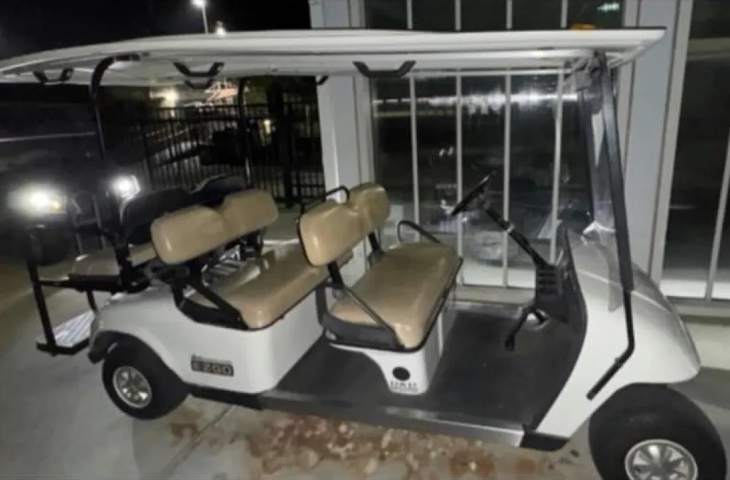 A white high-end golf cart with tan seats.