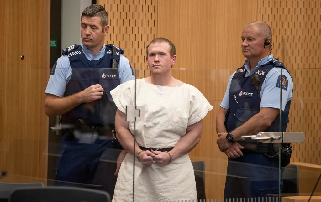 Tarrant (C), the man charged in relation to the Christchurch massacre, stands in the dock during his appearance at the Christchurch District Court.