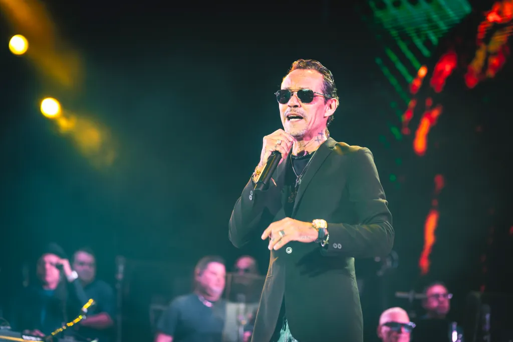Marc Anthony performing on stage during a concert.