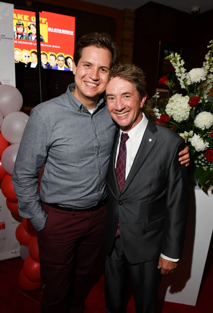 Martin Short and his son Henry Short smiling and posing for a photo.
